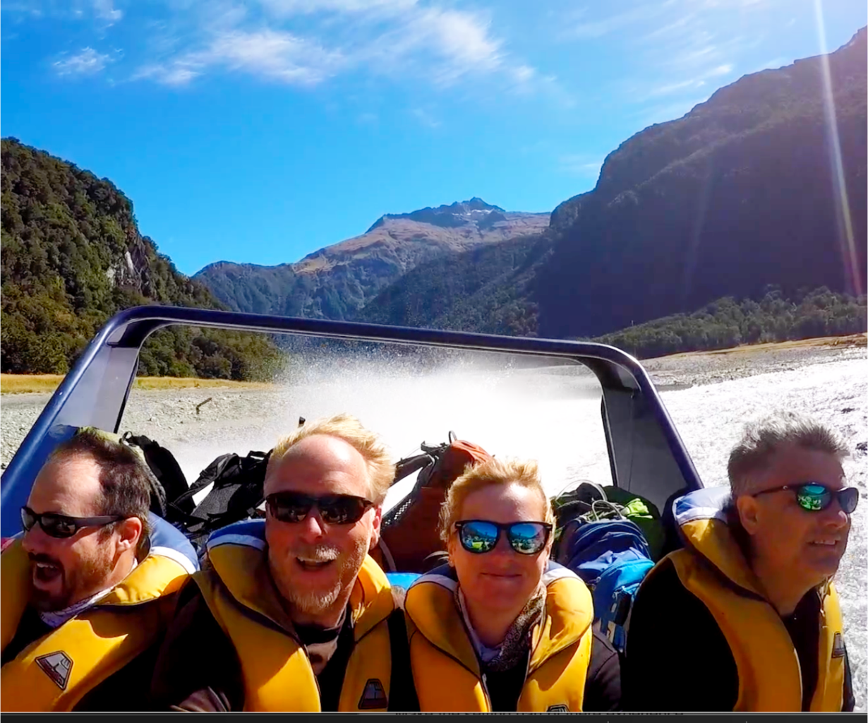 Adventure travelers riding in a jet boat