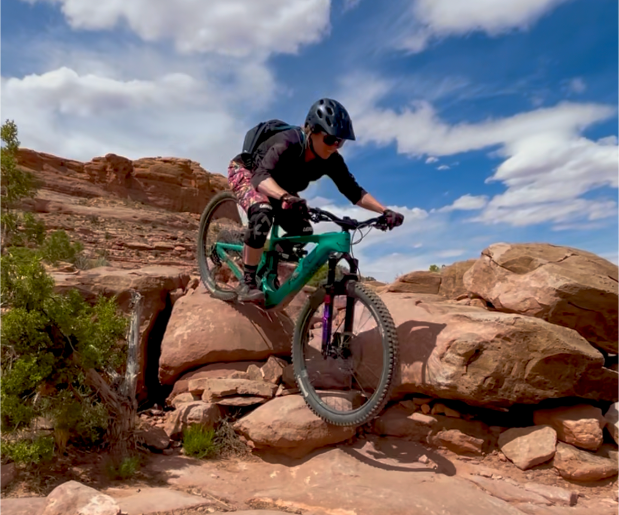 Mountain biker riding a technical rock feature