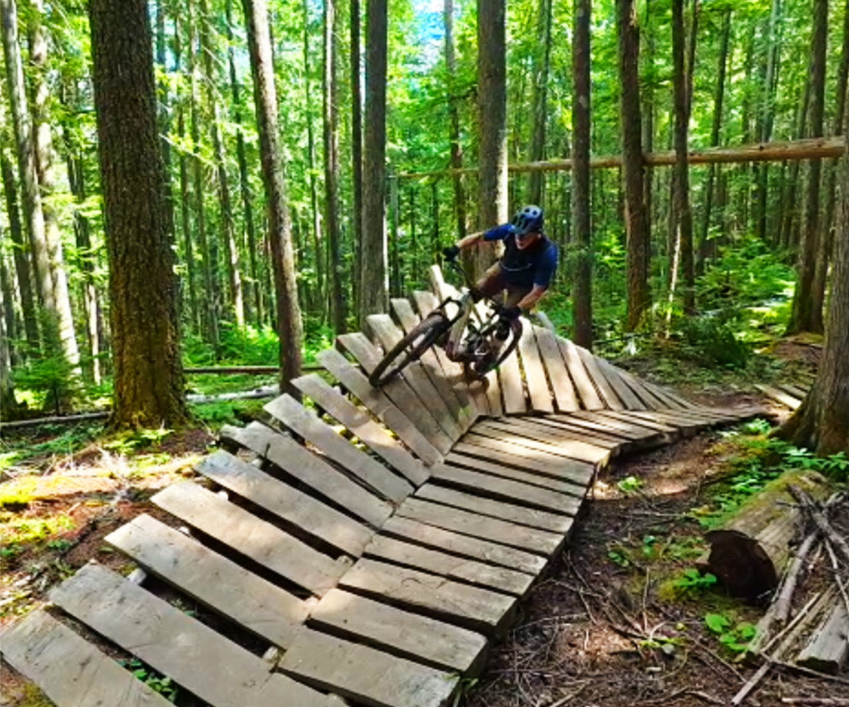 Mountain biker riding a wooden wall feature